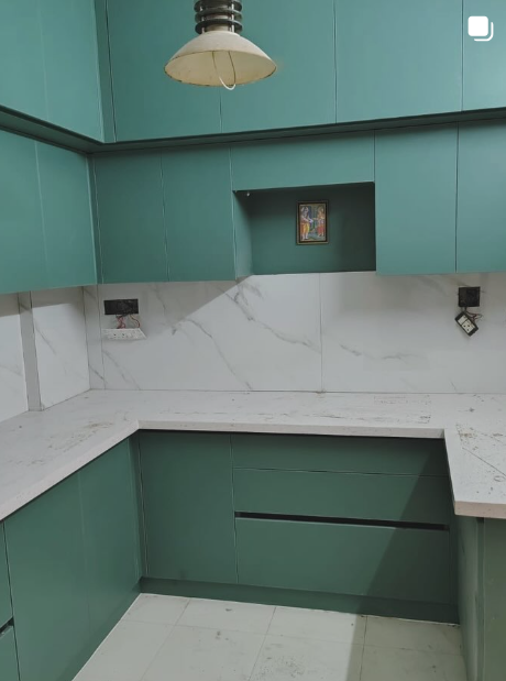 Renovated modular kitchen in sage green with marble backsplash and countertop