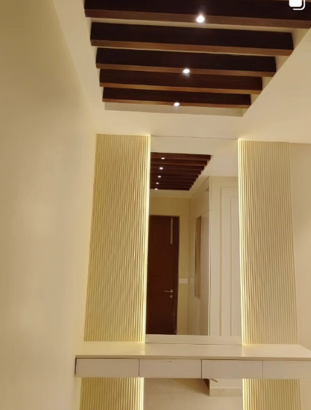 Warm backlit fluted foyer panelling with timber rafter ceiling by WooDint's